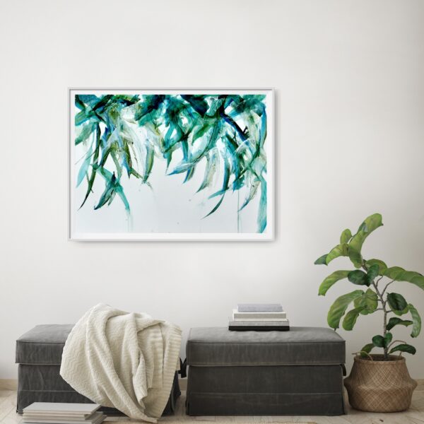Leaves in a breeze - Original artwork of a blue green leaves hanging from above and gently blowing in the breeze. The hanging leaves contain reflections from the light above. The painting conveys a sense of serenity and elegance. The painting is shown hanging on a pale wall behind a seat and decorating items.