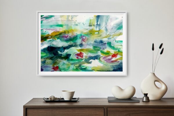 Monets Pond - an abstract original artwork of blue green water in a pond and red / pink lotus flowers floating on the surface of the water. The light reflects of the water and plants. The painting conveys and image of elegance and interest. the painting is hanging on a wall above a wooden cabinet with decorating items.