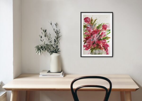 Red Roses - Original artwork of a vase filled with red roses and some green leaves. The roses have long stems and are in full bloom, showing their bright red petals. The vase reflects the light from a nearby window. The painting conveys a sense of romance and elegance. The painting is hanging on a pale wall above a wooden desk and decorating items.