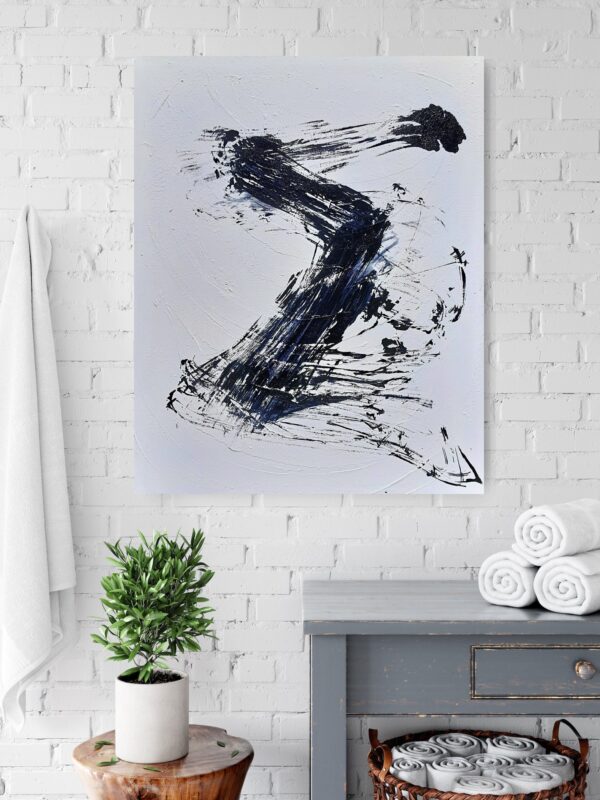 Rising to the Light - Zen art abstract black and white painting depicting movement in bold Asian style brushstrokes. The painting is hanging on a pale wall behind a table and a pot plant.