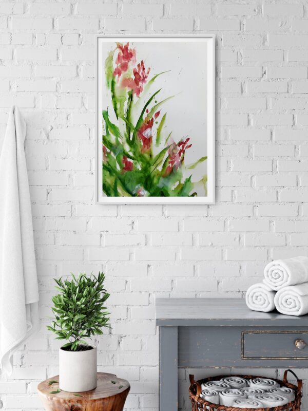 Delicate Orchid - A mixed media painting of luscious pink / red orchid flowers and green stems. The painting is hanging on a white brick wall above a wooden cabinet and decorating items.