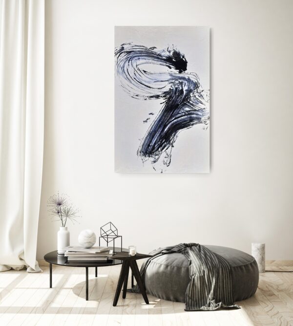 Power of the Serpent - Zen art abstract black and white painting depicting movement in bold Asian style brushstrokes. The painting is hanging on a pale wall above a seat, table and decorating items.
