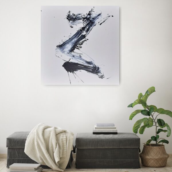 Rising to the Light - Zen art abstract black and white painting depicting movement in bold Asian style brushstrokes. The painting is hanging on a pale wall behind a seat and a pot plant.