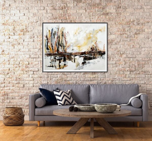 Lakeside Glory - An abstract landscape artwork portraying lake, trees, and the sky in natural colours of brown, ochre, black, white and grey. The painting is hanging on a brick wall, behind a sofa and coffee table.