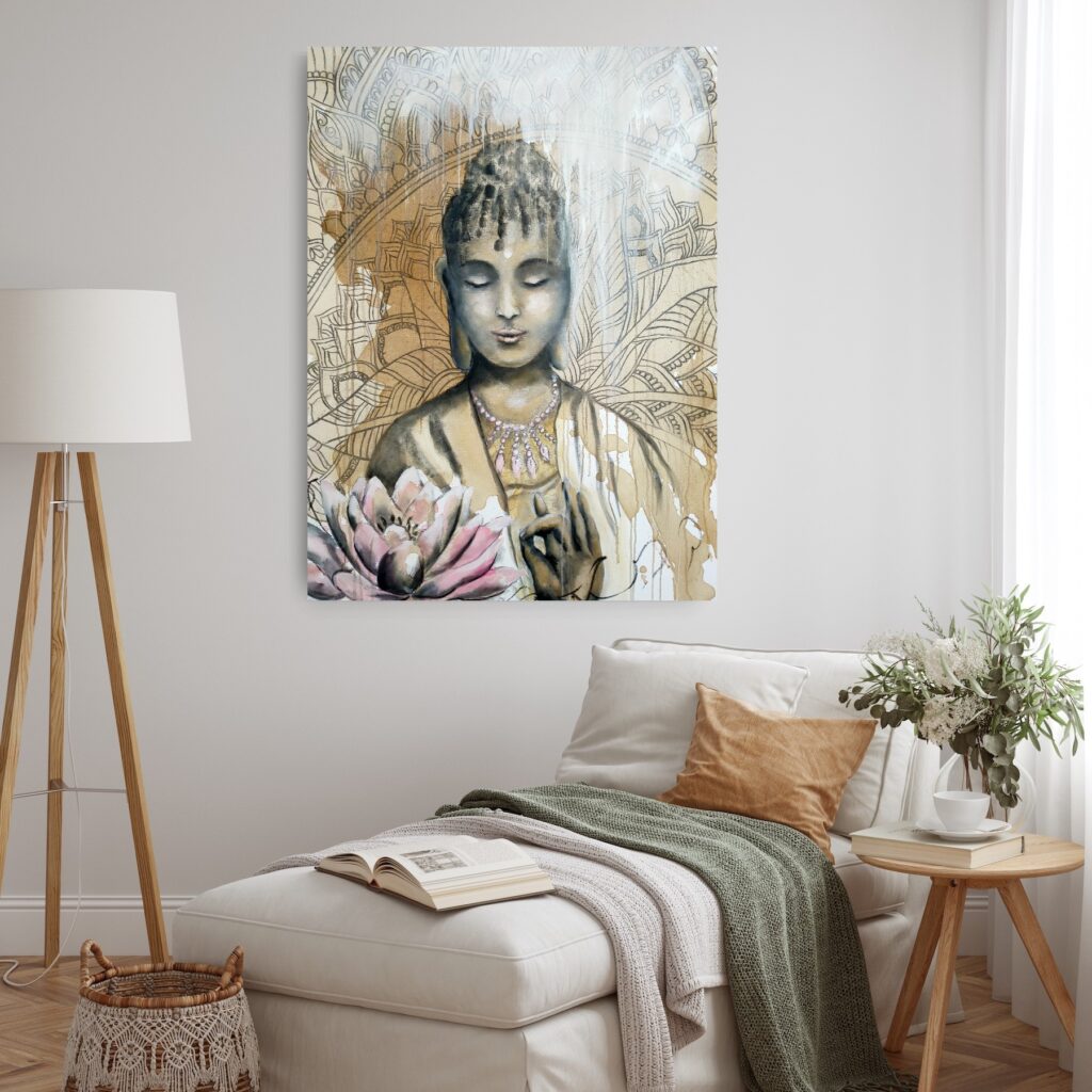 Quiet contemplation - a mixed media painting portraying a female Buddha meditating, a pale pink and ochre lotus flower in the foreground and an ochre mandala patterned background. Lotus flowers are representative of growing out of the muddy waters of life with purity, serenity and natural beauty. The painting is hanging on a pale wall behind a chaise lounge, small table and a large lamp.