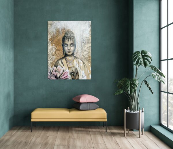 Quiet contemplation - a mixed media painting portraying a female Buddha meditating, a pale pink and ochre lotus flower in the foreground and an ochre mandala patterned background. Lotus flowers are representative of growing out of the muddy waters of life with purity, serenity and natural beauty. The painting is hanging on a pale wall behind a seat and a pot plant to the side.