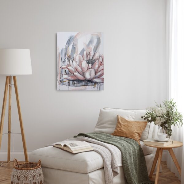 Blushed Lotus - a mixed media painting portrays pale pink lotus flowers with an abstract background amidst Asian calligraphy for love and peace. Lotus flowers are representative of growing out of the muddy waters of life with purity, serenity and natural beauty. The painting is hanging on a pale wall behind a chaise lounge, side table and tall lamp.