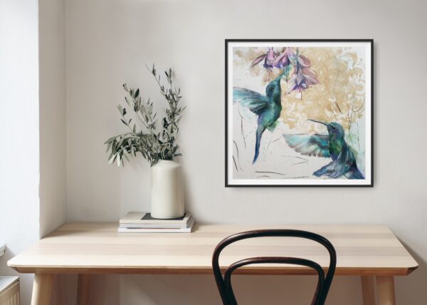 Hummingbird Jewels - abstract original artwork of two jade hummingbirds flying towards pink / purple, fuchsia flowers with an abstract ochre mandala pattern in the background shown in a room with a desk and chair.
