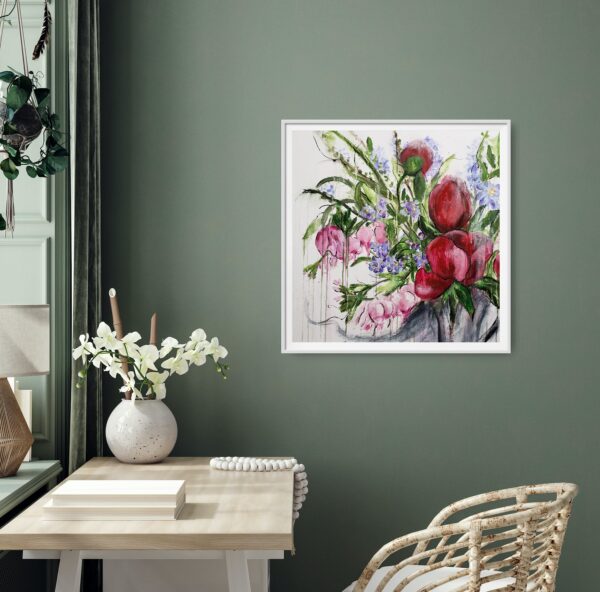 Opulence - This abstract mixed media artwork represents the beauty of nature with a vase of opulent red, pink and purple flowers amongst luscious green foliage. It is hanging on a green wall with a white desk & chair. There is a white vase of flowers, books, and mala beads on the desk.
