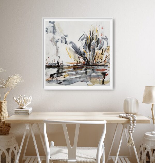 Stormy Outback - This abstract mixed media artwork portrays an outback lake, or billabong, with trees and scrubland emerging from the background amidst a storm. The painting is hanging a white wall in front of a desk and chair displaying decorating items.