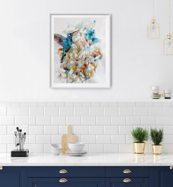 Jade Hummingbird in the Garden flying amongst turquoise, ochre and pink flowers and foliage original artwork in a room with dark blue set of cupboards like a kitchen.