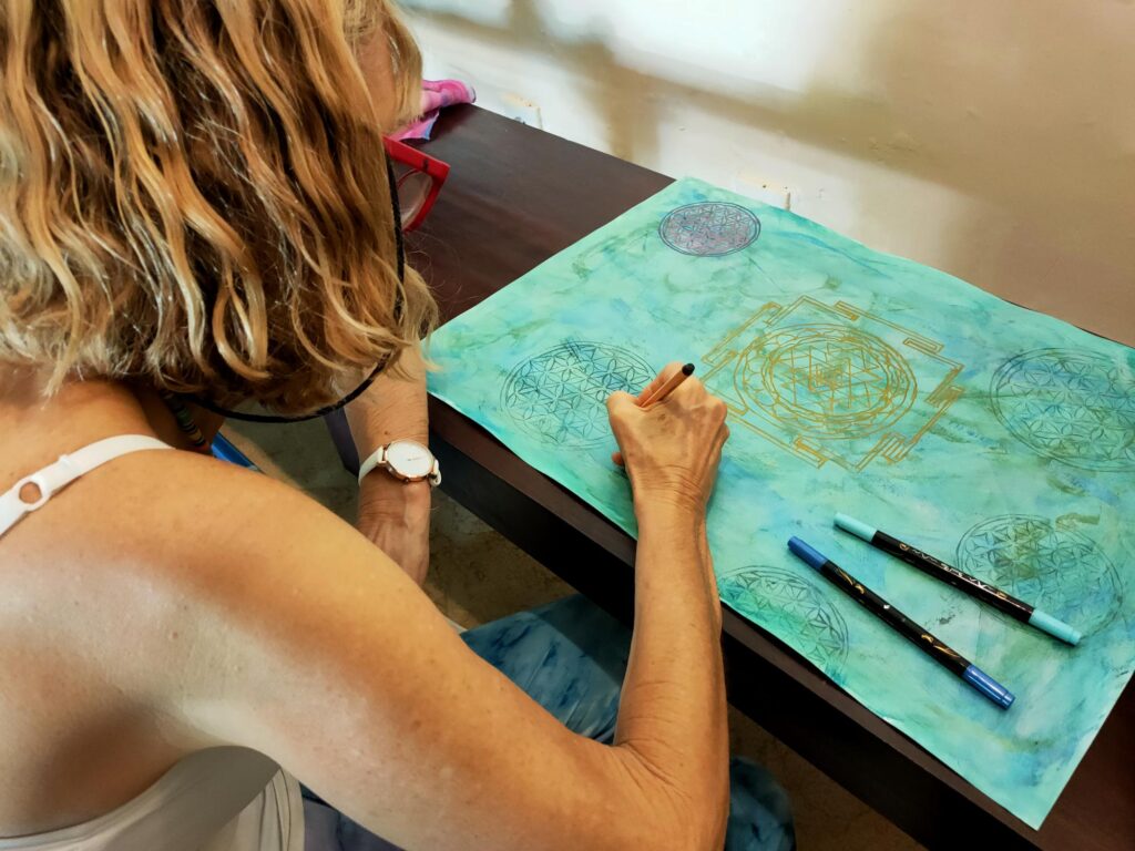 Participant painting a mandala painting at the Bali retreat.