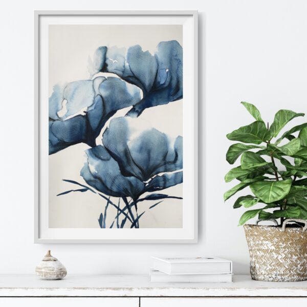 Abstract artwork of blue magnolias in an Asian inspired painting hanging over a desk with decorating items.