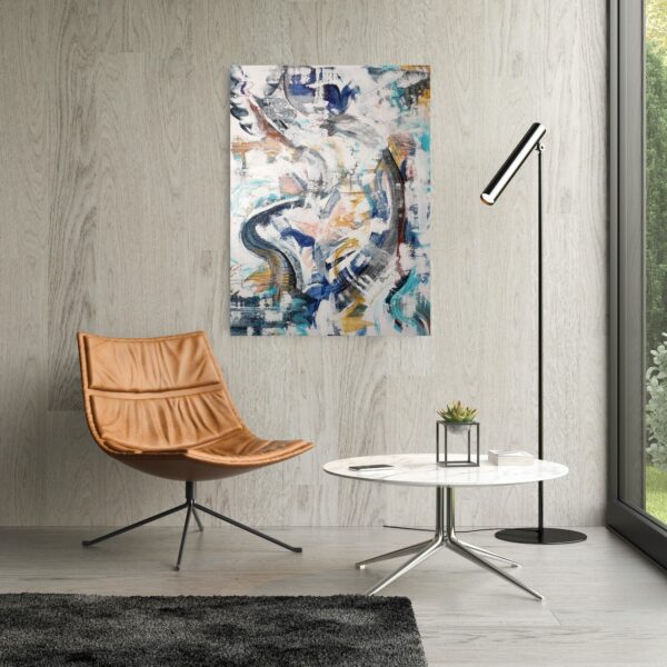 Swirling patterned abstract artwork featuring blues, turquoises, apricots, yellow ochres, white and black colours hanging on a wall above an ochre reading chair, small table and lamp.